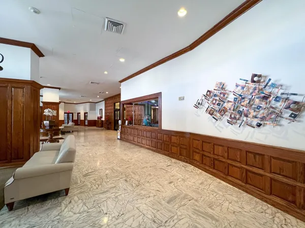 a view of a hallway to a livingroom and wooden floor