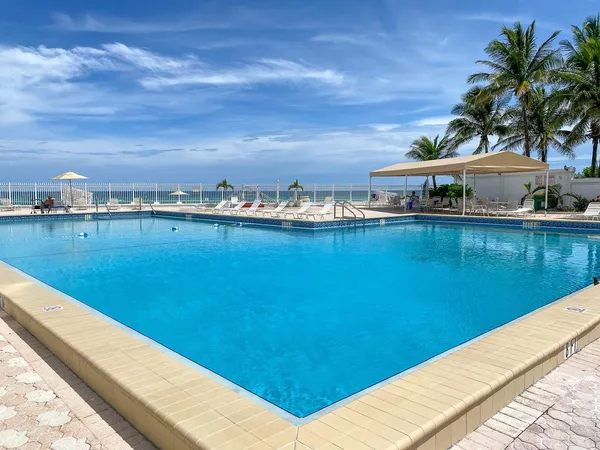 a view of a lake with a table and chairs