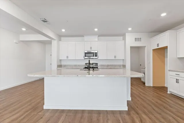 a view of kitchen with wooden floor and window