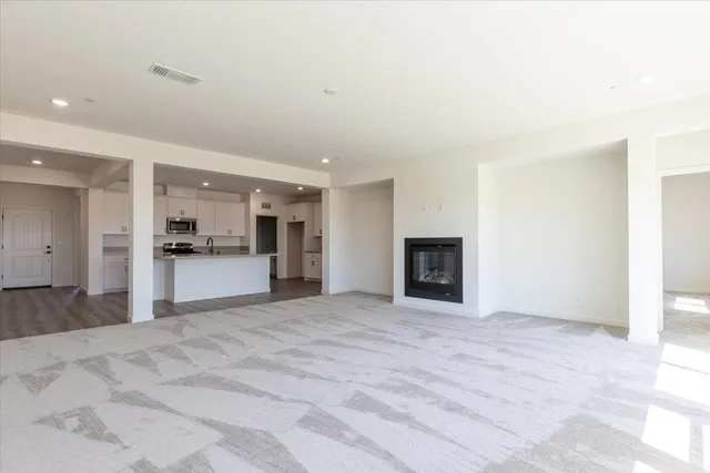 a view of a kitchen with a sink and a refrigerator