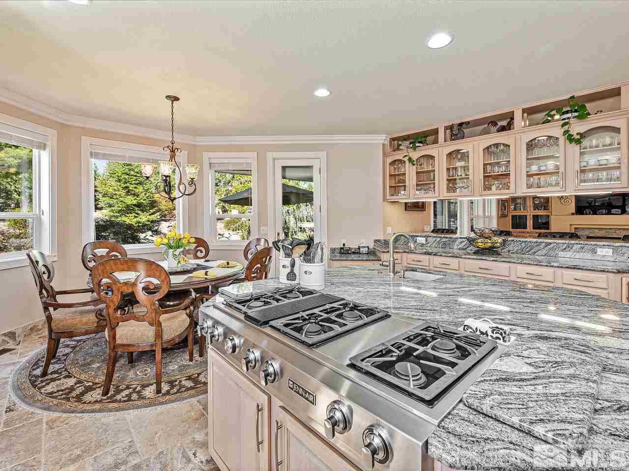 13215 West Saddlebow Drive Reno, NV 89511 - Photo 13 of 32 a table and chairs in a open kitchen