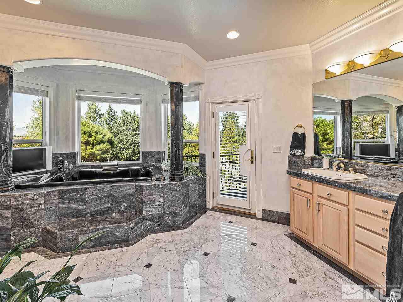 13215 West Saddlebow Drive Reno, NV 89511 - Photo 19 of 32 a large bathroom with a large tub and sink