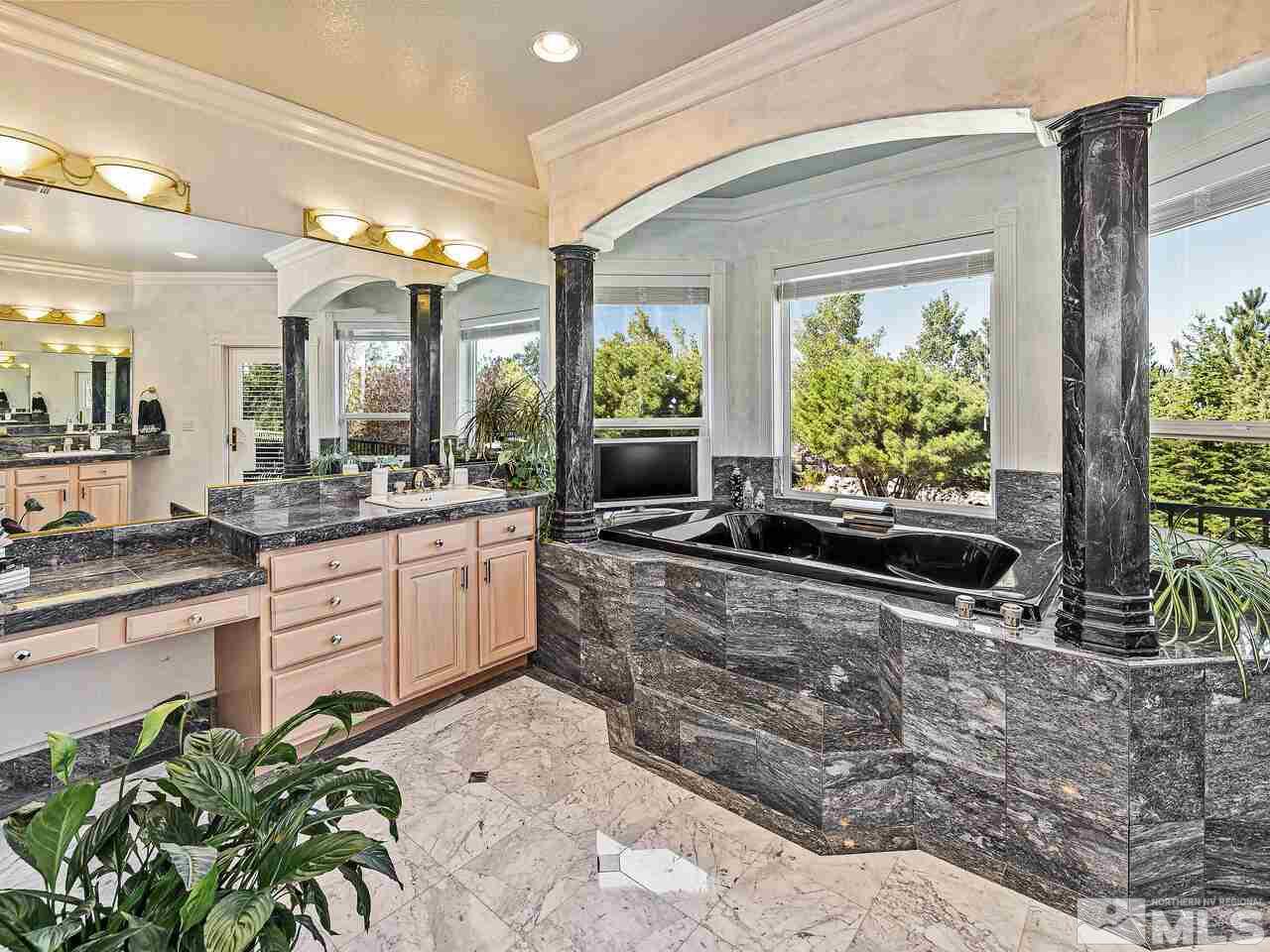 13215 West Saddlebow Drive Reno, NV 89511 - Photo 20 of 32 a large white kitchen with a large window and potted plant