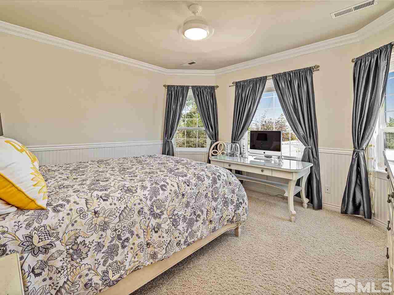 13215 West Saddlebow Drive Reno, NV 89511 - Photo 22 of 32 a bed sitting in a room next to a window