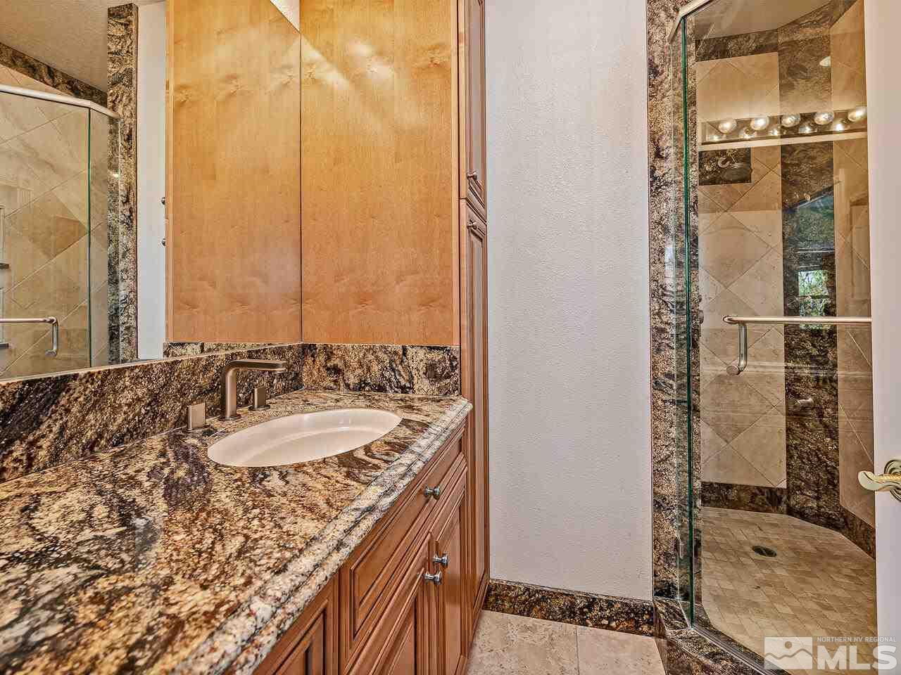13215 West Saddlebow Drive Reno, NV 89511 - Photo 25 of 32 a bathroom with a granite countertop sink and a mirror