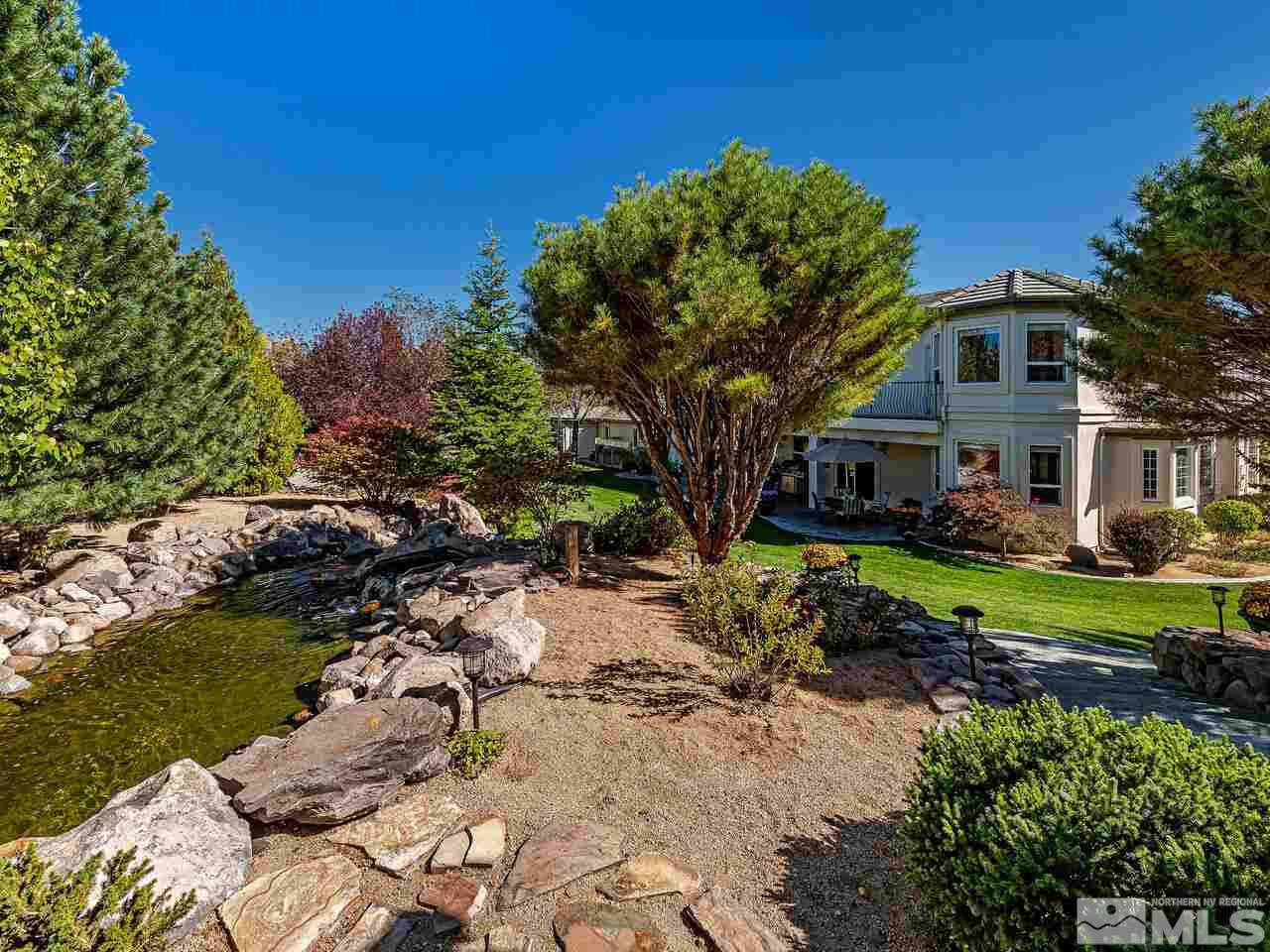 13215 West Saddlebow Drive Reno, NV 89511 - Photo 28 of 32 a front view of a house with a yard