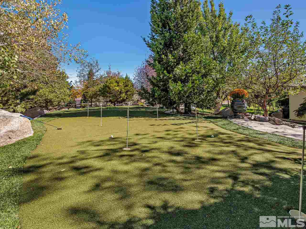 13215 West Saddlebow Drive Reno, NV 89511 - Photo 29 of 32 a swimming pool with outdoor seating and yard
