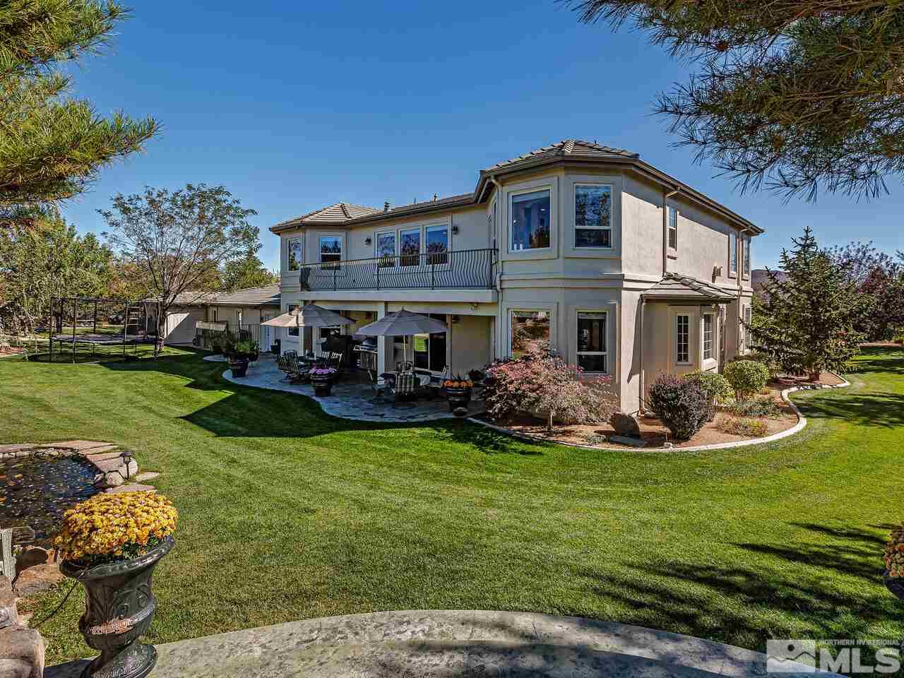 13215 West Saddlebow Drive Reno, NV 89511 - Photo 4 of 32 a front view of a house with garden