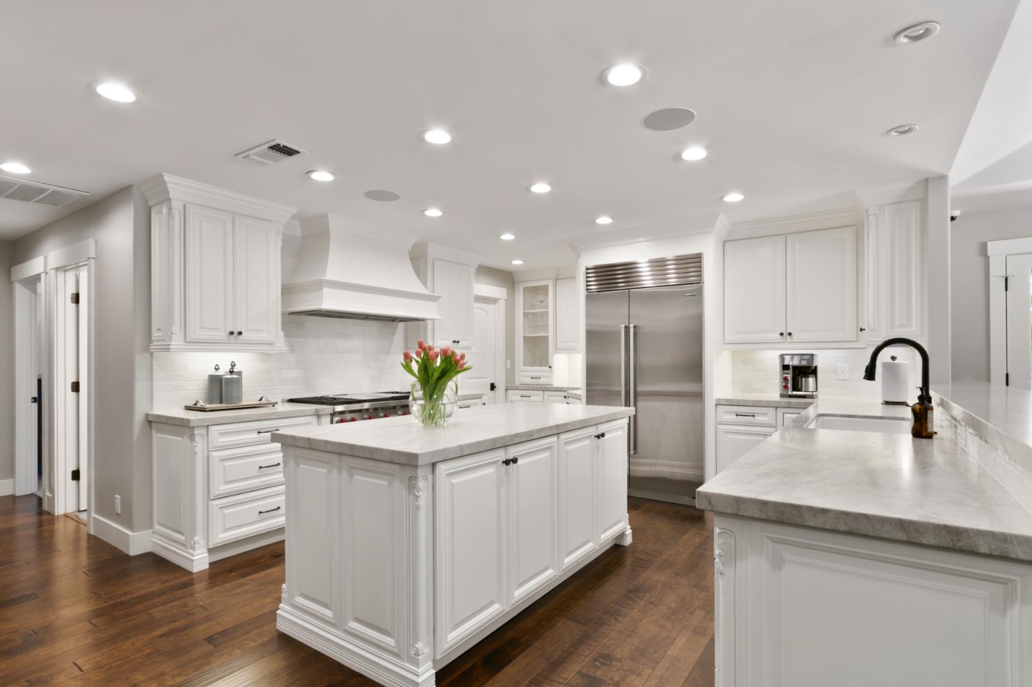 495 Bret Harte Road Sacramento, CA 95864 - Photo 20 of 84 a kitchen with white cabinets stainless steel appliances and wooden floor