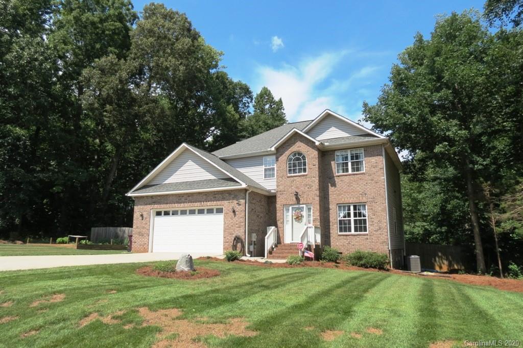 1173 Timber Spring Lane Salisbury, NC 28147 - Photo 2 of 38 a front view of a house with a yard and garage