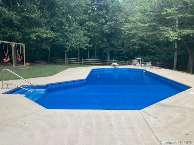 1173 Timber Spring Lane Salisbury, NC 28147 - Photo 11 of 38 a view of swimming pool with seating area and trees in the background