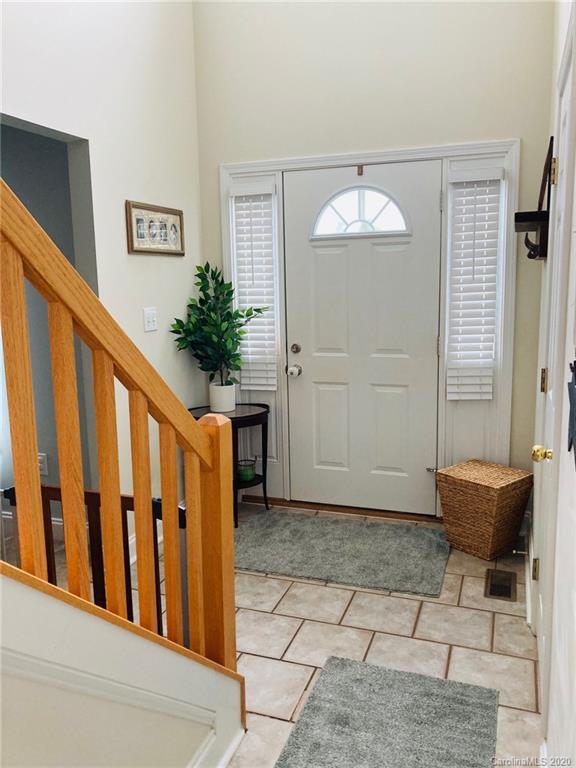 1173 Timber Spring Lane Salisbury, NC 28147 - Photo 12 of 38 a view of a hallway with wooden floor and a potted plant