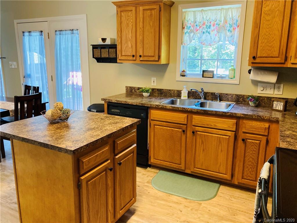 1173 Timber Spring Lane Salisbury, NC 28147 - Photo 17 of 38 a kitchen with stainless steel appliances granite countertop wooden cabinets a sink and dishwasher