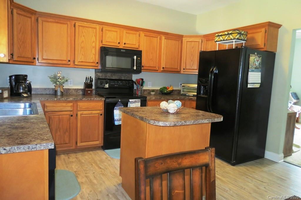 1173 Timber Spring Lane Salisbury, NC 28147 - Photo 18 of 38 a kitchen with stainless steel appliances granite countertop a refrigerator a stove a sink and a microwave
