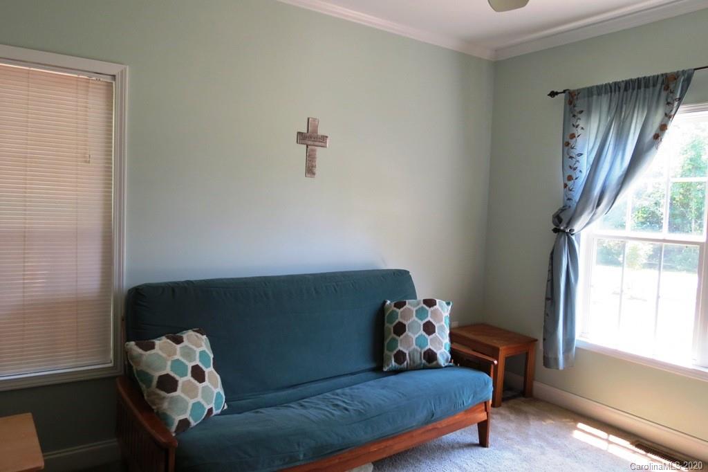 1173 Timber Spring Lane Salisbury, NC 28147 - Photo 21 of 38 a bed sitting in a bedroom next to a window