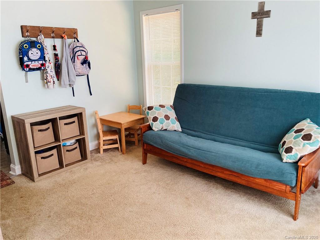 1173 Timber Spring Lane Salisbury, NC 28147 - Photo 22 of 38 a living room with furniture and a baby crib