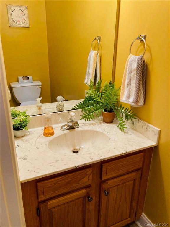 1173 Timber Spring Lane Salisbury, NC 28147 - Photo 24 of 38 a bathroom with a granite countertop sink and a mirror