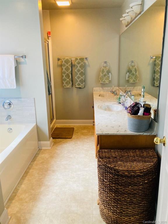 1173 Timber Spring Lane Salisbury, NC 28147 - Photo 27 of 38 a bathroom with a granite countertop sink and a bathtub