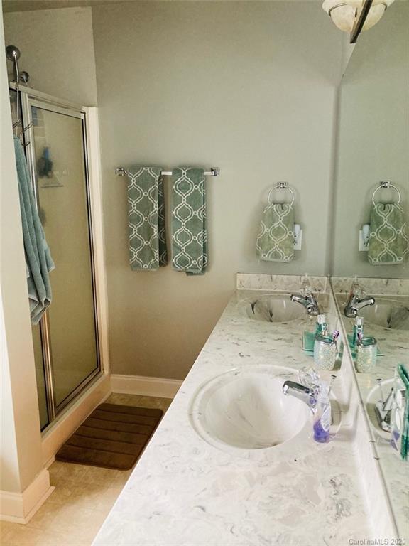 1173 Timber Spring Lane Salisbury, NC 28147 - Photo 28 of 38 a bathroom with a tub sink and mirror