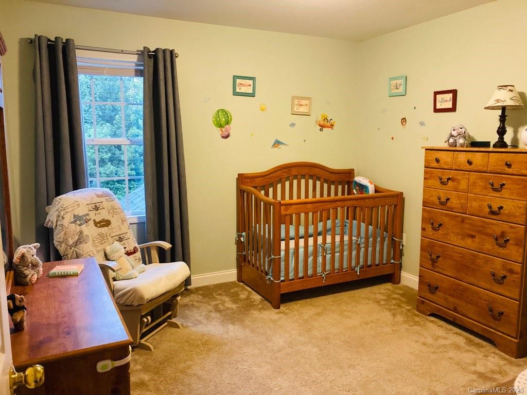 1173 Timber Spring Lane Salisbury, NC 28147 - Photo 32 of 38 a bedroom with a bed and wooden floor