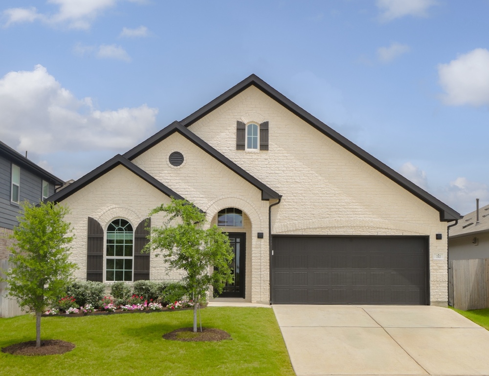 a front view of a house with garden