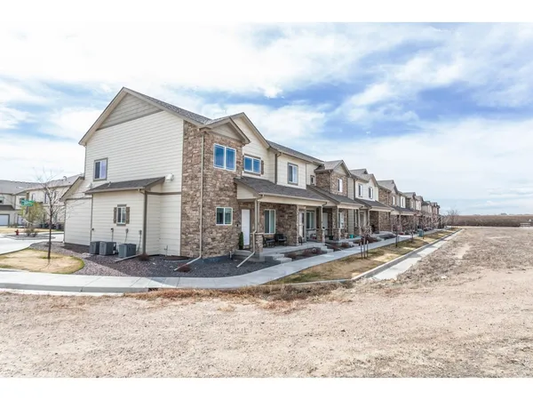 a view of a very nice looking house with a yard