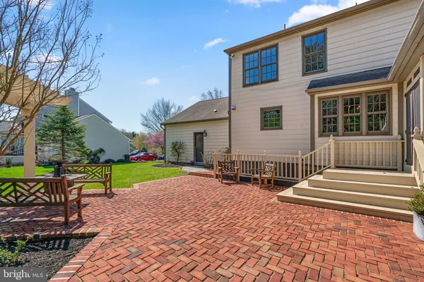 a view of house with backyard and outdoor seating