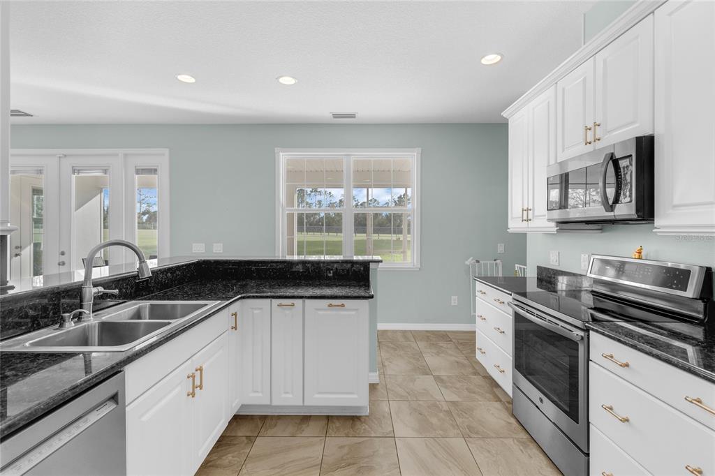 5608 Strong Point Weirsdale, FL 32195 - Photo 14 of 71 a kitchen that has a sink and a stove