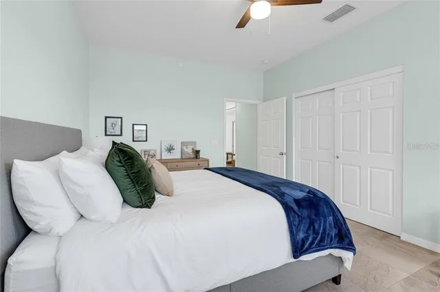 a living room with furniture a ceiling fan and a window