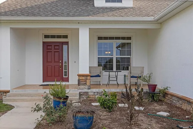 a living room with furniture ceiling fan and a window