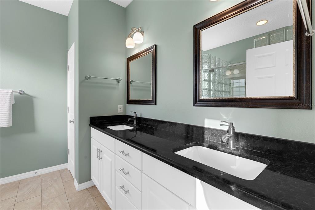 5608 Strong Point Weirsdale, FL 32195 - Photo 23 of 71 a bathroom with double sink and a mirror