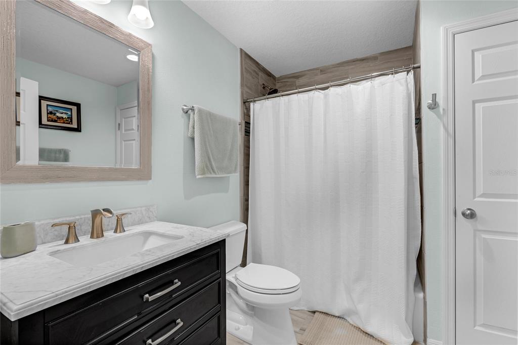 5608 Strong Point Weirsdale, FL 32195 - Photo 26 of 71 a bathroom with a sink and a toilet