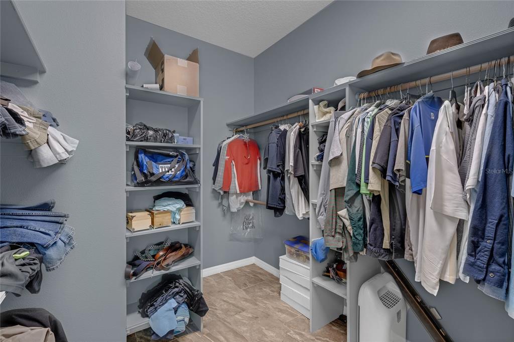 5608 Strong Point Weirsdale, FL 32195 - Photo 27 of 71 a view of walk in closet with clothes and shoes