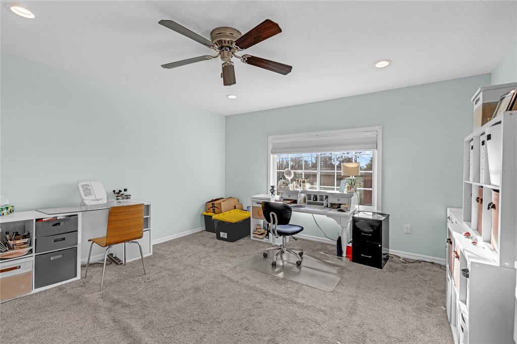 5608 Strong Point Weirsdale, FL 32195 - Photo 29 of 71 a living room with furniture and a window