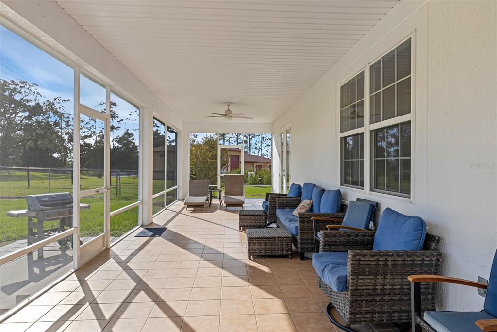 5608 Strong Point Weirsdale, FL 32195 - Photo 35 of 71 a living room with furniture and a floor to ceiling window