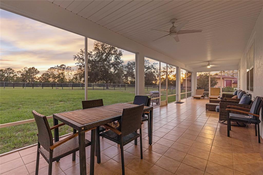 5608 Strong Point Weirsdale, FL 32195 - Photo 37 of 71 a view of a patio with a backyard dining table and chairs