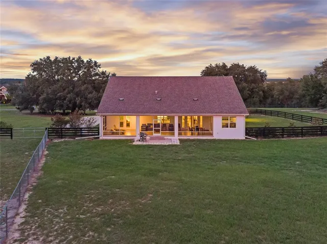 a aerial view of a house next to a yard