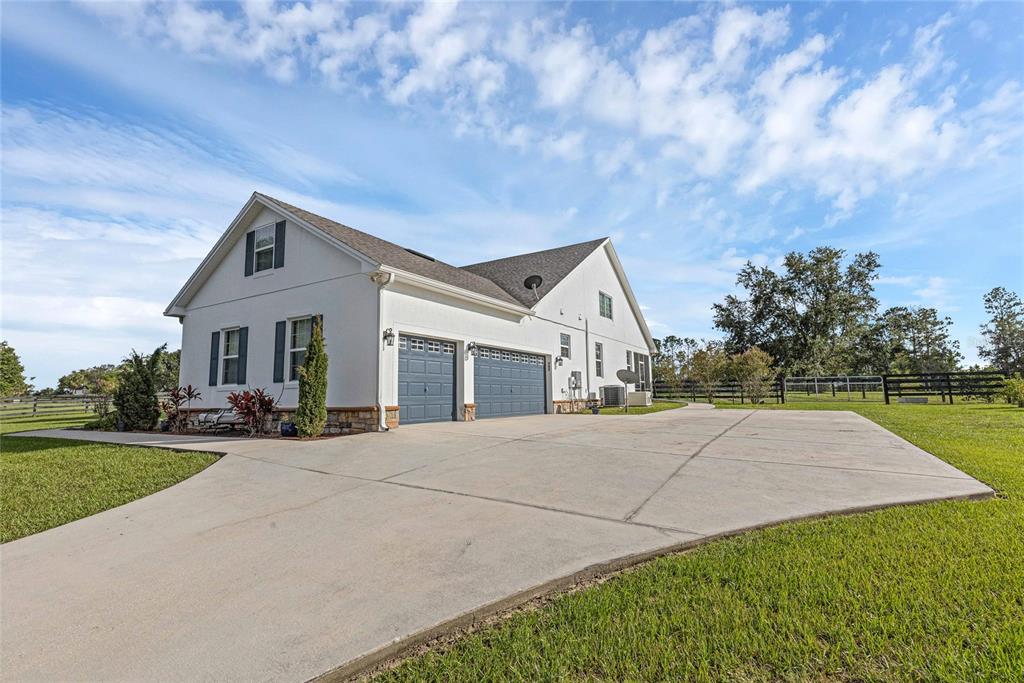 5608 Strong Point Weirsdale, FL 32195 - Photo 40 of 71 a front view of a house with a yard and garage