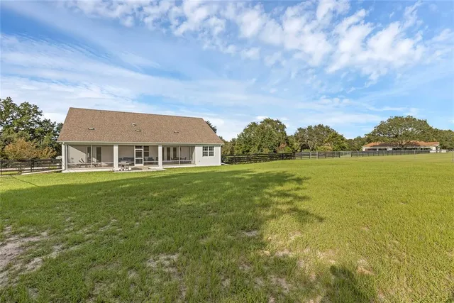 an aerial view of a house with big yard