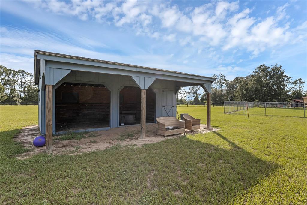 5608 Strong Point Weirsdale, FL 32195 - Photo 45 of 71 a view of a swimming pool with a bench in front of house
