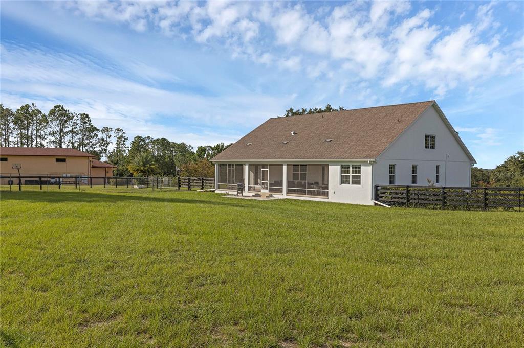 5608 Strong Point Weirsdale, FL 32195 - Photo 48 of 71 a front view of a house with a garden