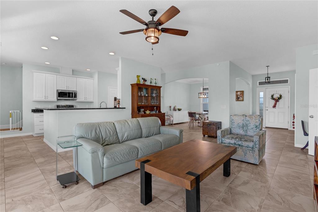 5608 Strong Point Weirsdale, FL 32195 - Photo 6 of 71 a living room with furniture kitchen view and a chandelier