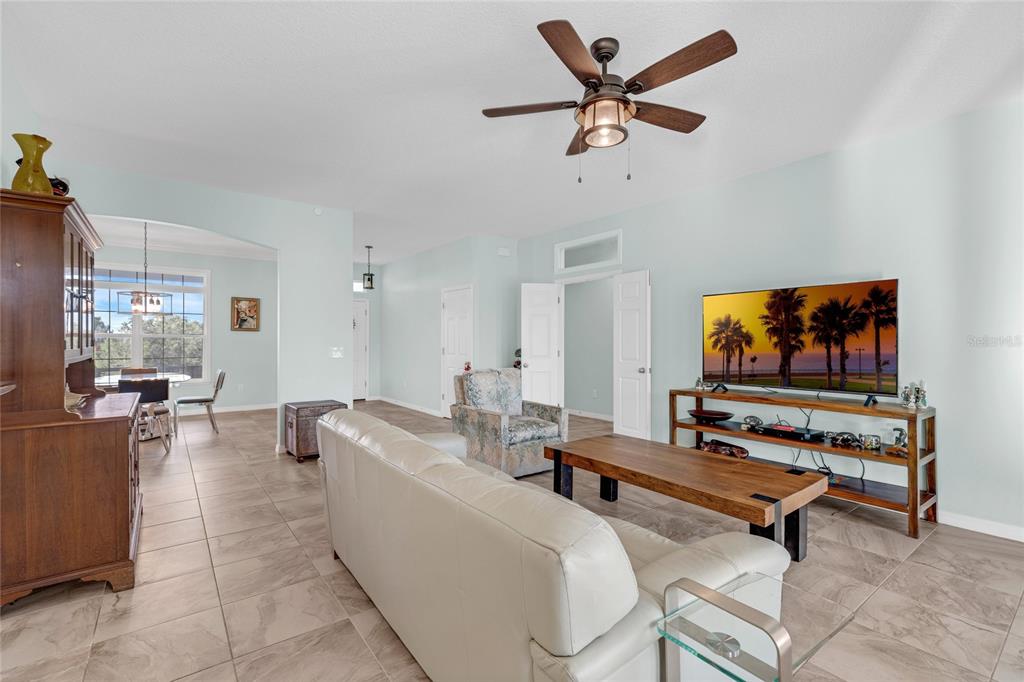 5608 Strong Point Weirsdale, FL 32195 - Photo 7 of 71 a living room with furniture and a flat screen tv