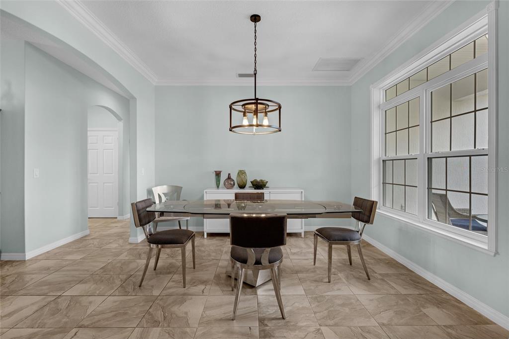 5608 Strong Point Weirsdale, FL 32195 - Photo 9 of 71 a view of a dining room with furniture window and wooden floor