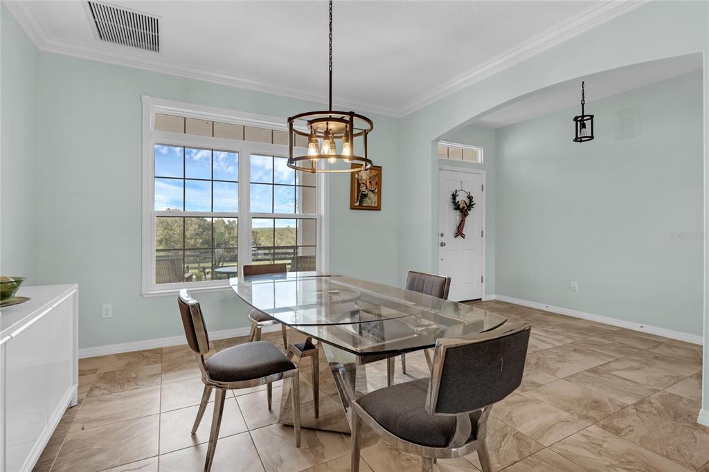 5608 Strong Point Weirsdale, FL 32195 - Photo 10 of 71 a view of a dining room with furniture window and outside view