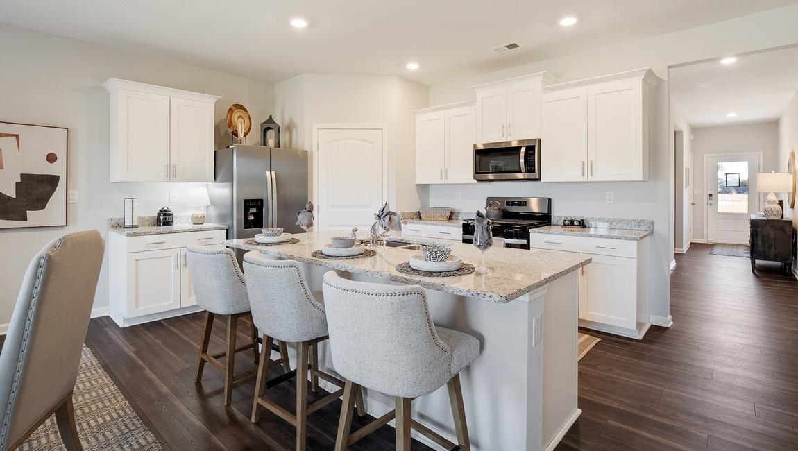 17 Azalea Drive Somerville, TN 38068 - Photo 7 of 28 a kitchen with stainless steel appliances kitchen island granite countertop a sink and cabinets