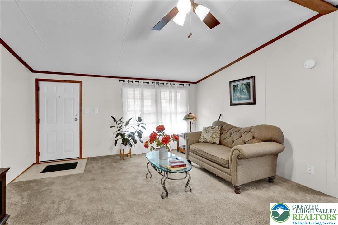 8758 Turkey Ridge Road, Unit 180 Breinigsville, PA 18031 - Photo 13 of 28 a living room with furniture and a flat screen tv