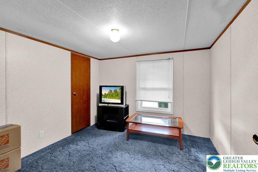 8758 Turkey Ridge Road, Unit 180 Breinigsville, PA 18031 - Photo 22 of 28 a spacious bedroom with a bed and a window