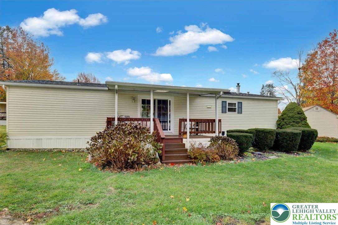 8758 Turkey Ridge Road, Unit 180 Breinigsville, PA 18031 - Photo 5 of 28 a backyard of a house with table and chairs
