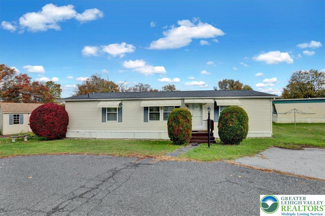 8758 Turkey Ridge Road, Unit 180 Breinigsville, PA 18031 - Photo 9 of 28 a view of a house with a backyard and a patio
